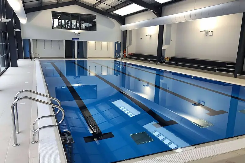 An indoor lap pool with lane ropes