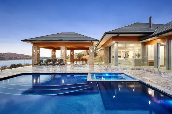 A clear blue pool in front of a modern house