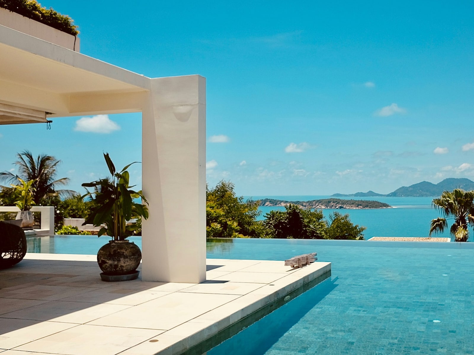 Infinity pool overlooking a blue bay and distant islands